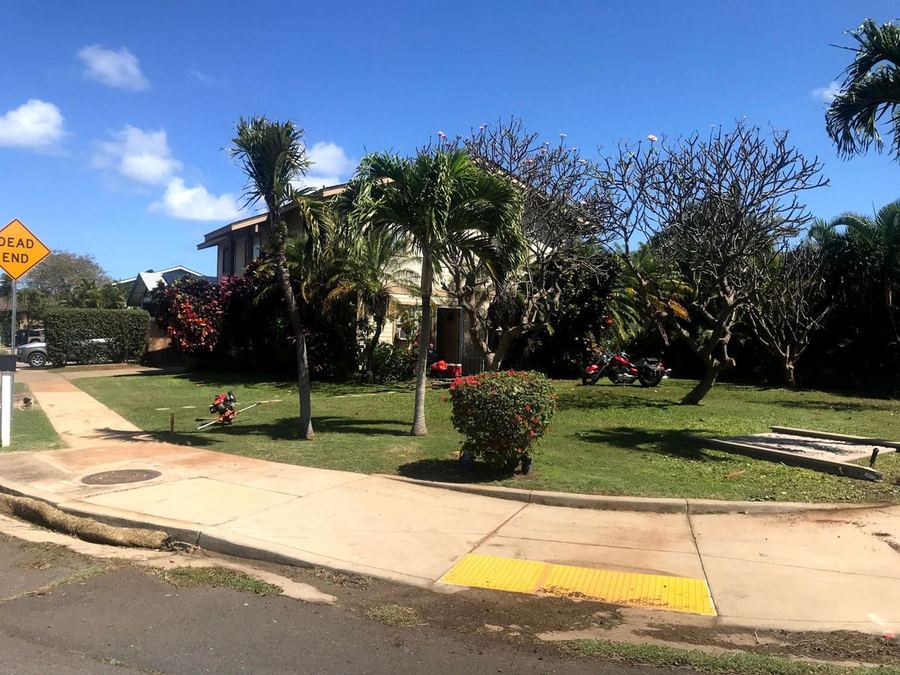 Open front yard along the street before the wall